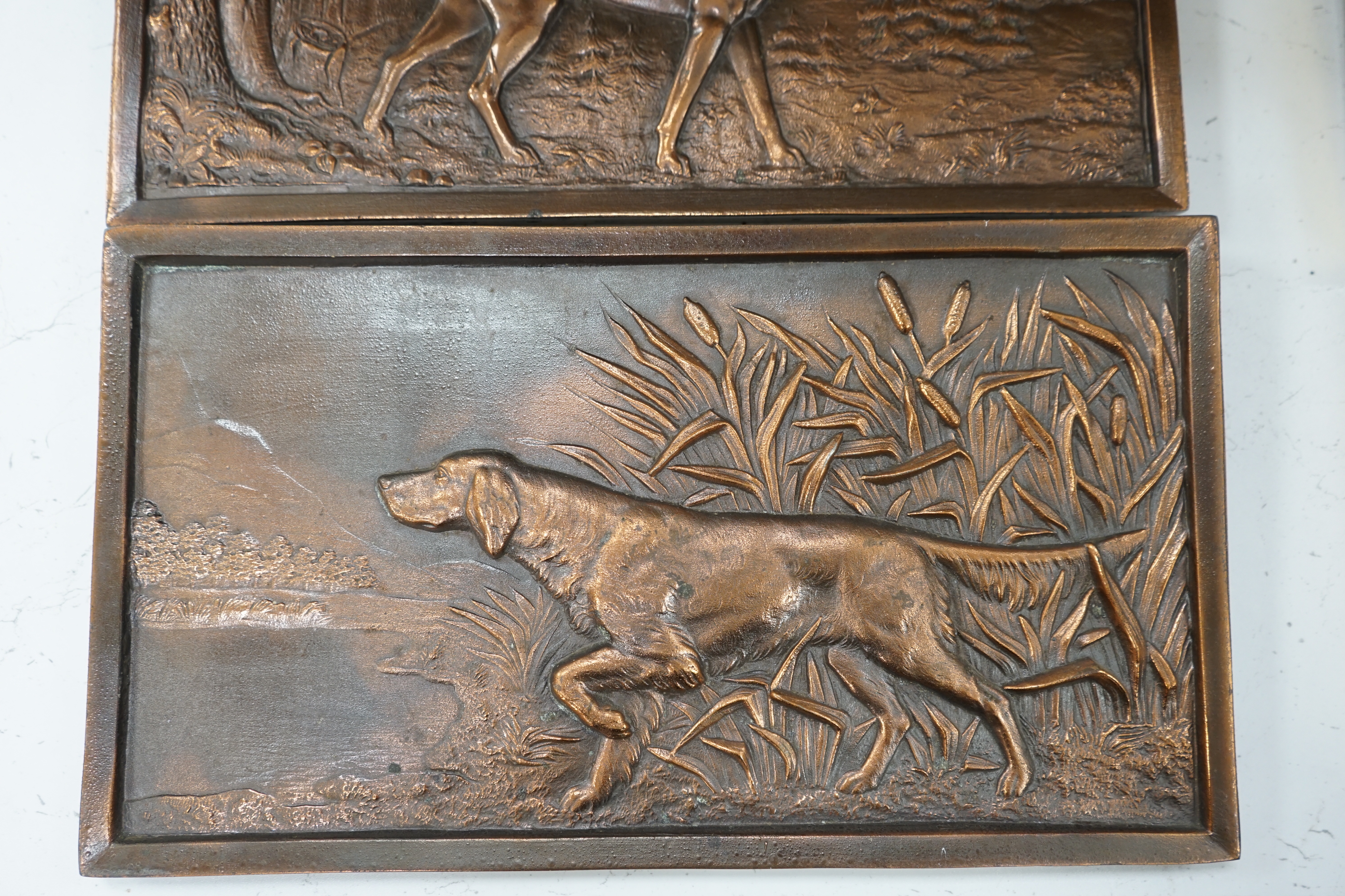 A pair of cast metal plaques of retrievers, 21 x 37cm